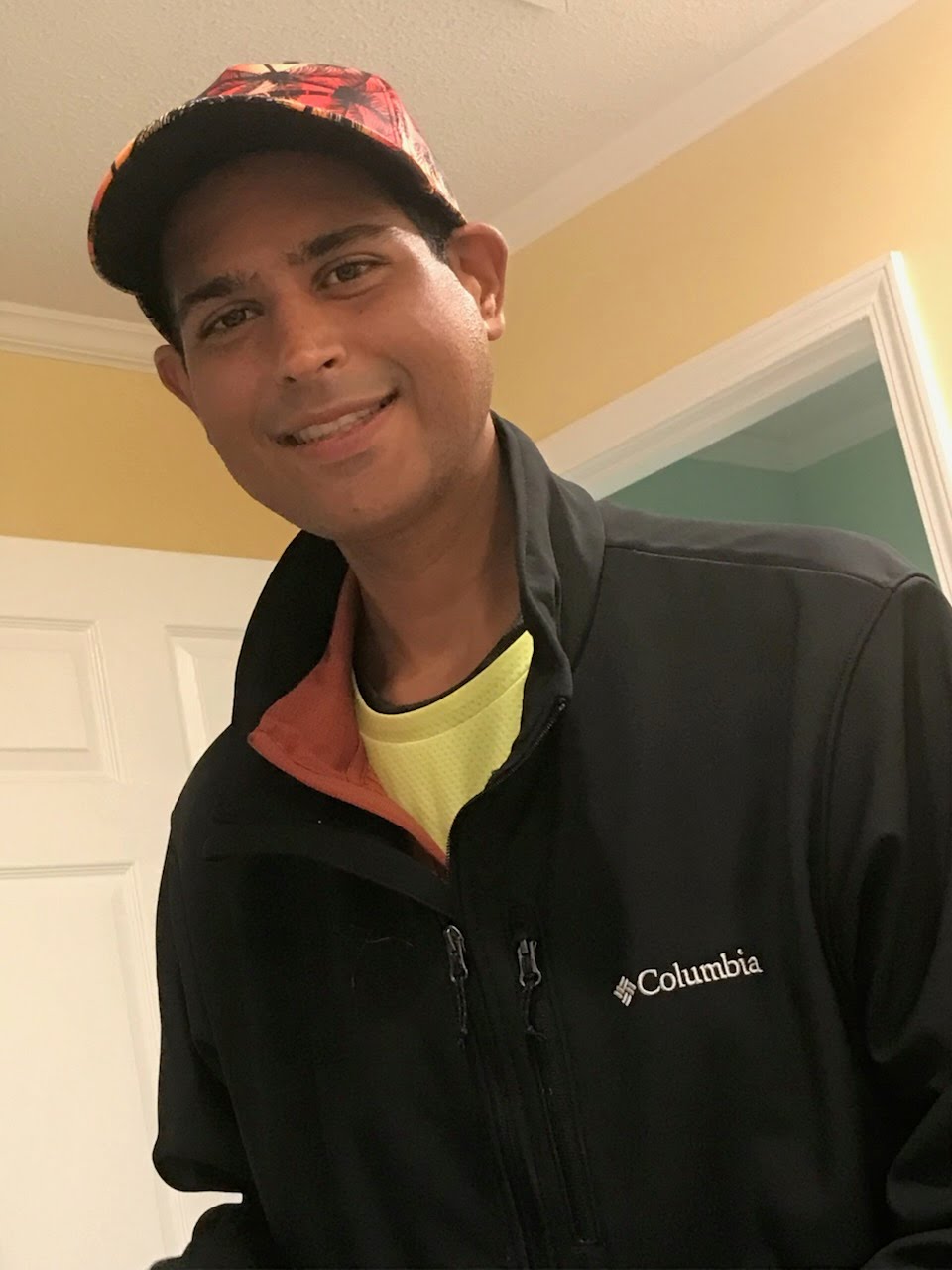 Brian smiling, wearing a cap and jacket