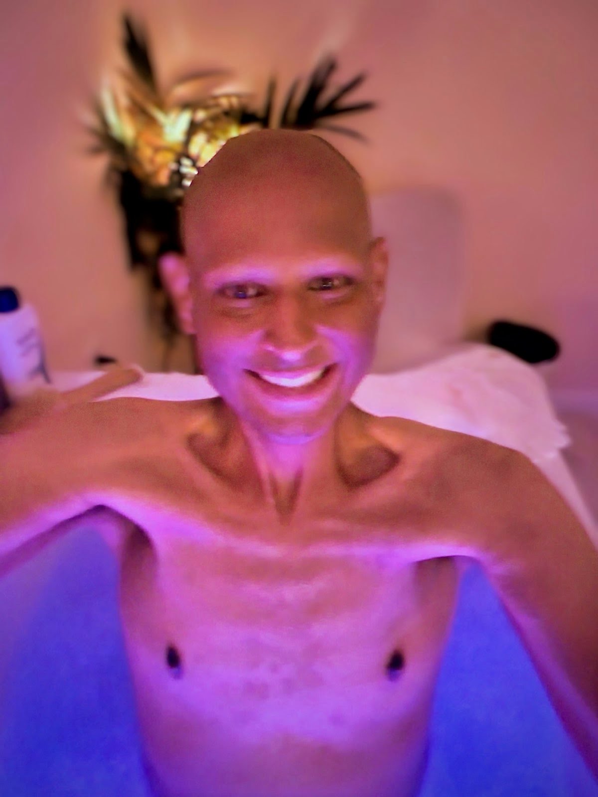 Brian smiling in a therapeutic bath during an earlier chapter of his journey